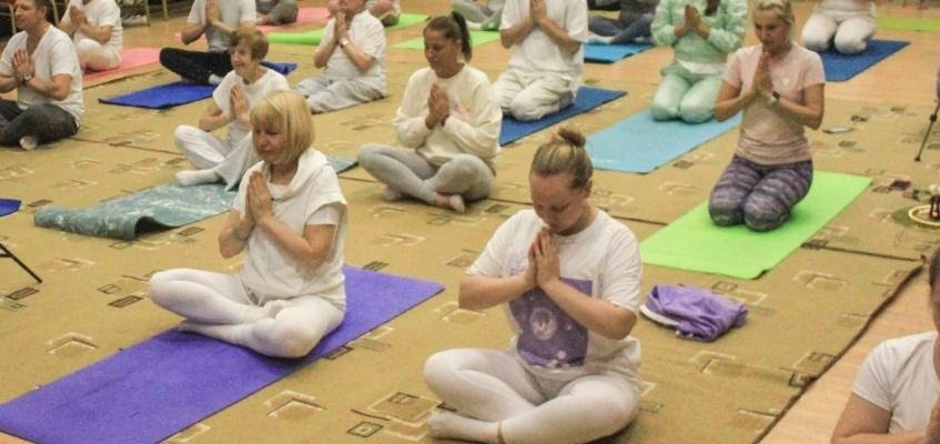 Ощутите энергию Люди сидят на ковриках для йоги